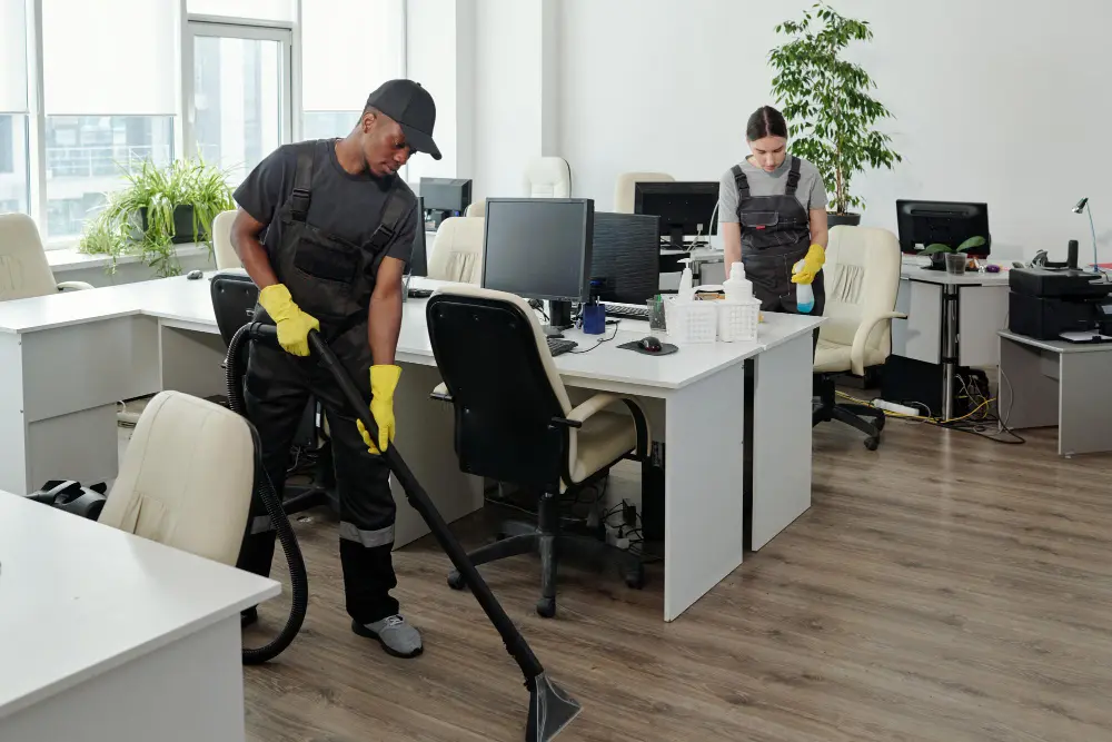 Cleaning technician disinfecting a computer monitor in a Commerce, CA bank.